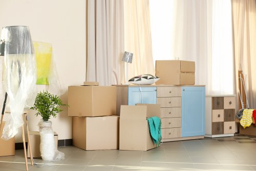 Professional piano movers using specialist lifting equipment