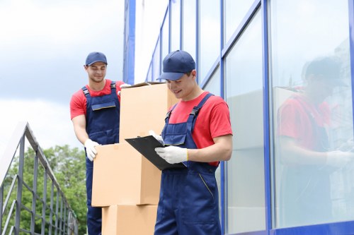 Removalists in Barnes protecting and lifting a large sofa during a home move