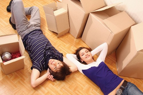 Worker using safe lifting technique with furniture