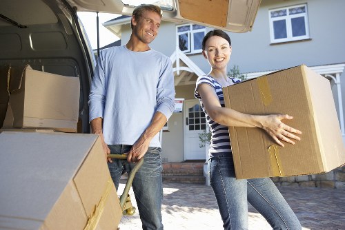 Moving van loading near Barnes with careful handling of furniture