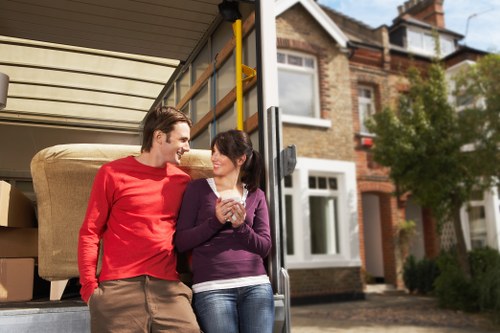Professional movers navigating stairs during a Barnes flat relocation