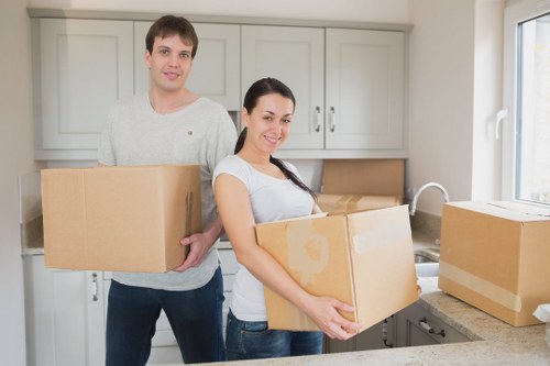Movers carrying furniture during a same day house move in Barnes